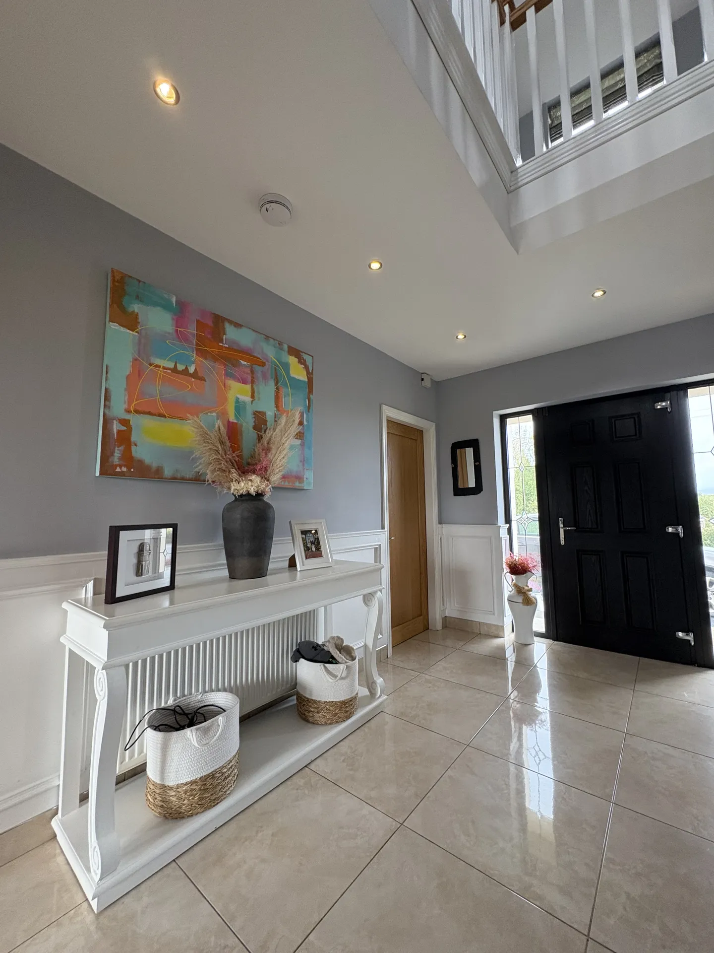 Grand entrance hall with original artwork at Golf Lodge